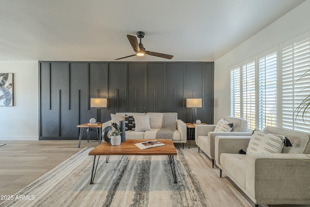 living room with ceiling fan and light hardwood / wood-style floors