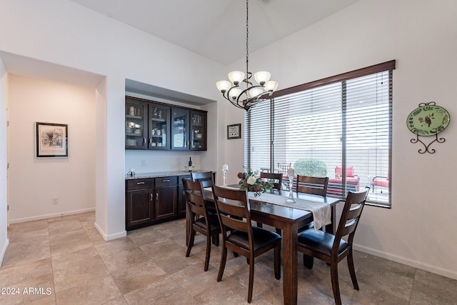 dining space with a chandelier and baseboards