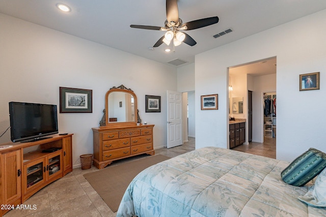 bedroom with light tile patterned floors, ensuite bathroom, a closet, a spacious closet, and ceiling fan