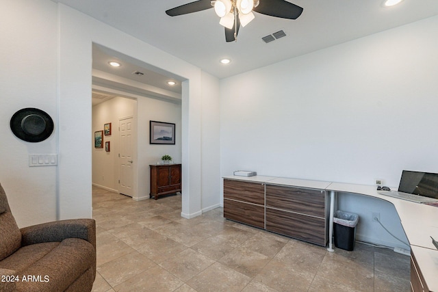 home office with built in desk and ceiling fan