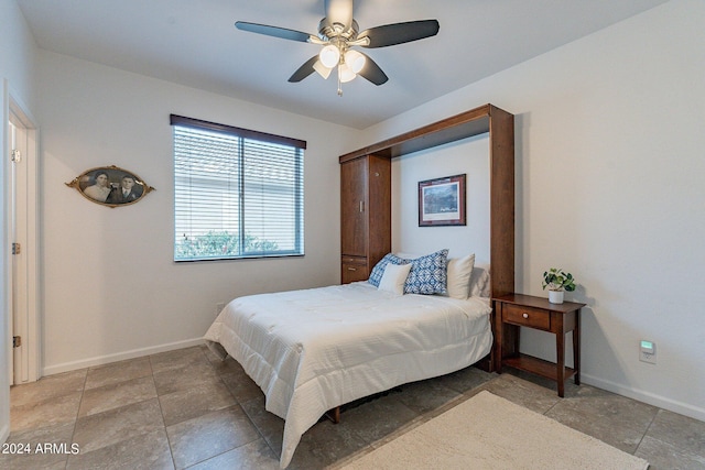 bedroom featuring ceiling fan and baseboards