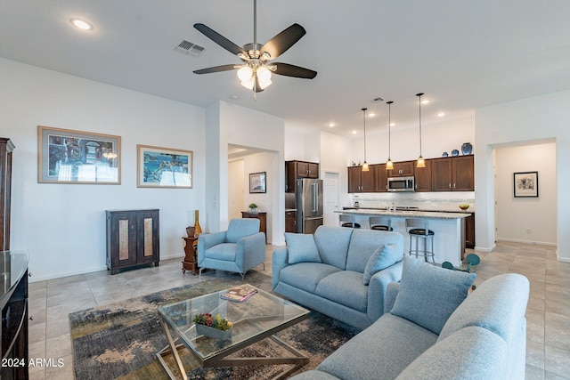 tiled living room featuring ceiling fan