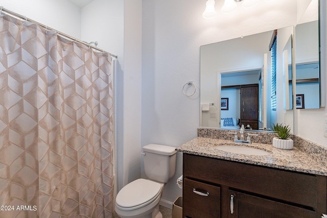 full bathroom with toilet, vanity, and a shower with shower curtain