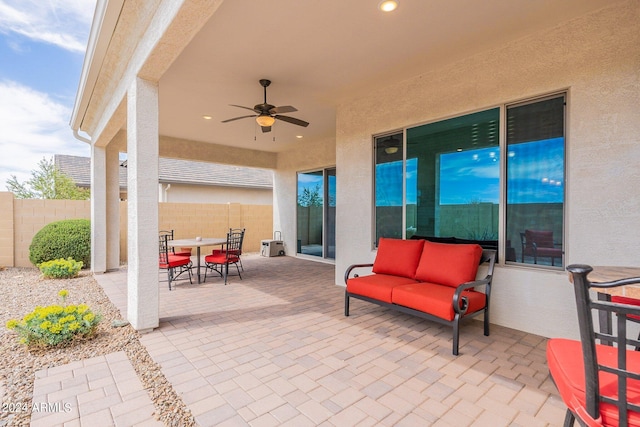 view of patio / terrace featuring outdoor dining area, ceiling fan, and fence