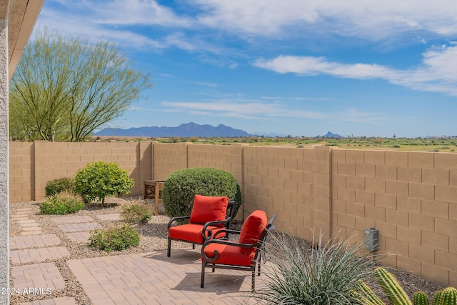 view of patio / terrace with a fenced backyard and a mountain view