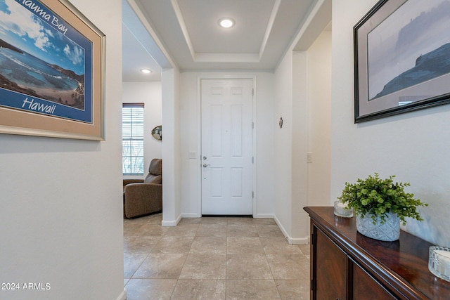 entrance foyer with recessed lighting, baseboards, a raised ceiling, and light tile patterned flooring