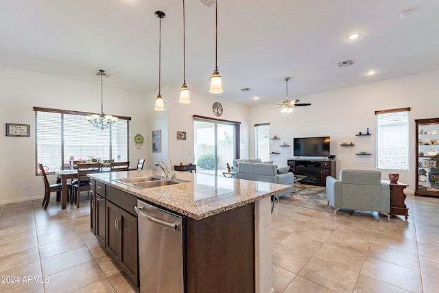 kitchen featuring stainless steel dishwasher, dark brown cabinetry, pendant lighting, and a sink