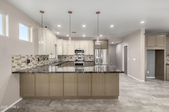 1918 E Megan St, Gilbert, AZ 85295 - kitchen with appliances with stainless steel finishes, dark stone countertops, a peninsula, backsplash, and recessed lighting