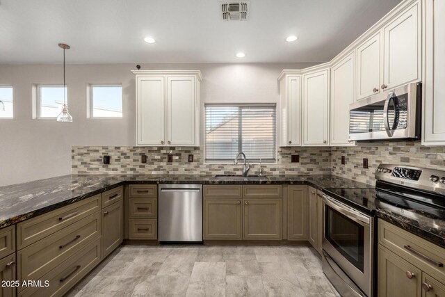 1918 E Megan St, Gilbert, AZ 85295 - kitchen featuring appliances with stainless steel finishes, plenty of natural light, decorative backsplash, dark stone counters, and recessed lighting