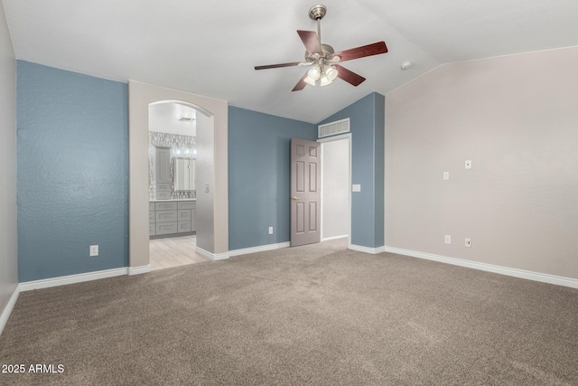 1918 E Megan St, Gilbert, AZ 85295 - unfurnished bedroom featuring light carpet, lofted ceiling, arched walkways, connected bathroom, and a ceiling fan