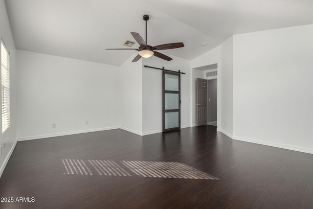 1918 E Megan St, Gilbert, AZ 85295 - spare room with vaulted ceiling, a barn door, a ceiling fan, and dark wood-style flooring
