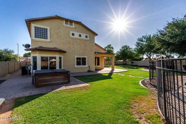 1918 E Megan St, Gilbert, AZ 85295 - rear view of property featuring a hot tub, a fenced backyard, a patio, and stucco siding