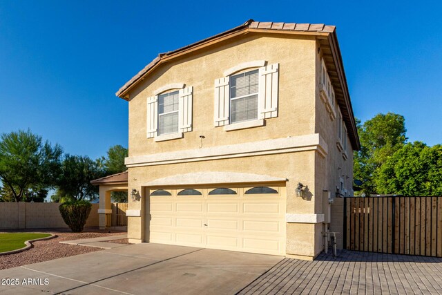 1918 E Megan St, Gilbert, AZ 85295 - view of front facade featuring concrete driveway, an attached garage, and stucco siding