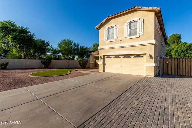 1918 E Megan St, Gilbert, AZ 85295 - view of side of home with a garage, concrete driveway, and stucco siding