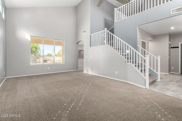 1918 E Megan St, Gilbert, AZ 85295 - unfurnished living room with a high ceiling, stairway, carpet, and arched walkways