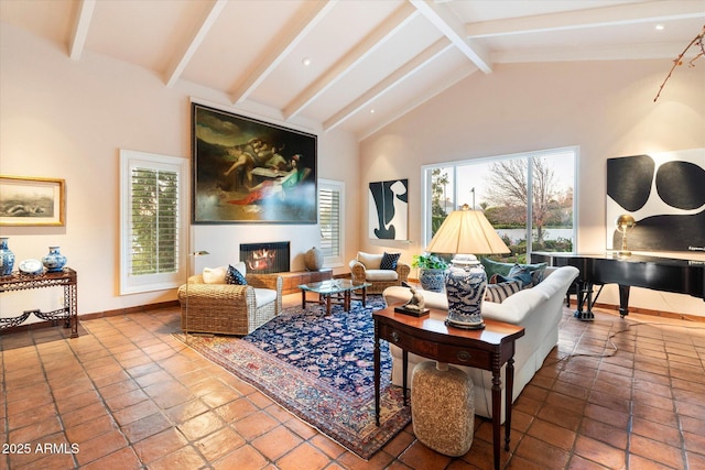 84 Biltmore Est, Phoenix, AZ 85016 - living room featuring a glass covered fireplace, high vaulted ceiling, baseboards, and beam ceiling