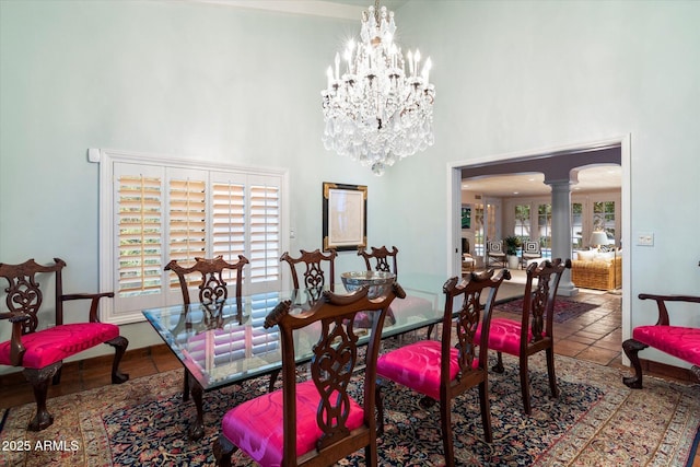 84 Biltmore Est, Phoenix, AZ 85016 - dining space featuring an inviting chandelier, tile patterned floors, a high ceiling, ornate columns, and arched walkways