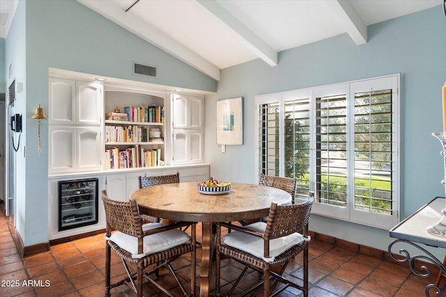 84 Biltmore Est, Phoenix, AZ 85016 - dining area featuring lofted ceiling with beams, visible vents, beverage cooler, tile patterned floors, and baseboards