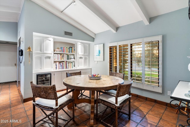 84 Biltmore Est, Phoenix, AZ 85016 - dining room featuring visible vents, baseboards, beverage cooler, and lofted ceiling with beams