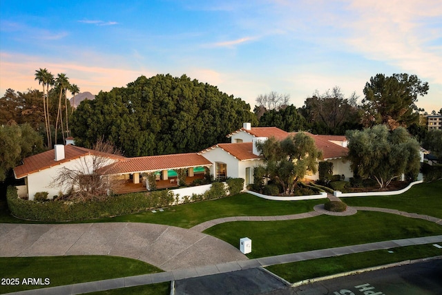84 Biltmore Est, Phoenix, AZ 85016 - view of front of home featuring stucco siding, a chimney, a front lawn, and a tile roof