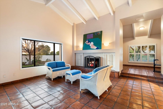 84 Biltmore Est, Phoenix, AZ 85016 - tiled living room featuring beam ceiling, baseboards, high vaulted ceiling, and a tile fireplace