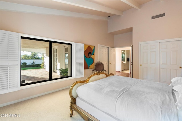 84 Biltmore Est, Phoenix, AZ 85016 - carpeted bedroom with visible vents, baseboards, beamed ceiling, multiple closets, and high vaulted ceiling