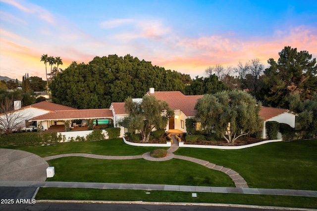 84 Biltmore Est, Phoenix, AZ 85016 - view of front facade with a tiled roof, a front yard, and stucco siding