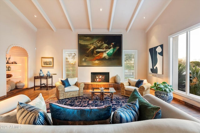 84 Biltmore Est, Phoenix, AZ 85016 - living area featuring a lit fireplace, wood finished floors, baseboards, and beam ceiling