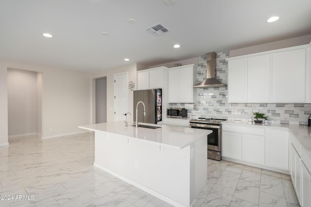 kitchen featuring marble finish floor, stainless steel appliances, visible vents, a sink, and wall chimney range hood