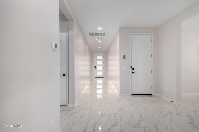 hallway with marble finish floor, recessed lighting, visible vents, and baseboards