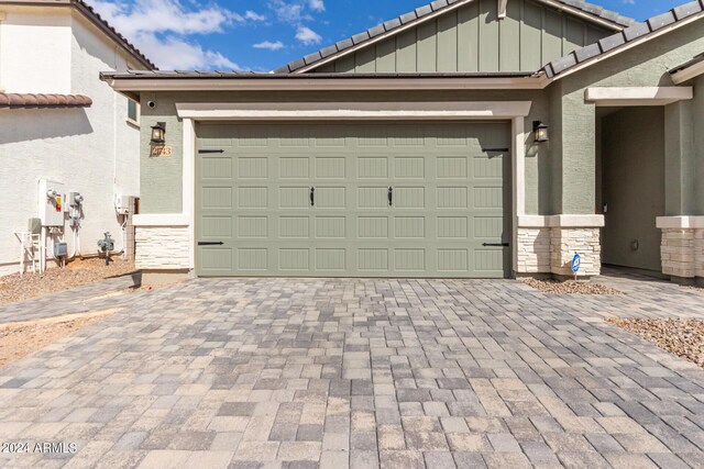 garage with decorative driveway