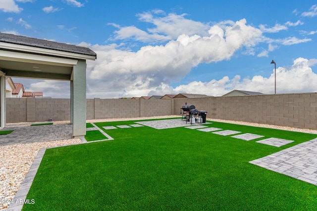 view of yard featuring a patio area and a fenced backyard