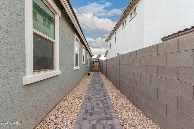 view of property exterior with fence and stucco siding