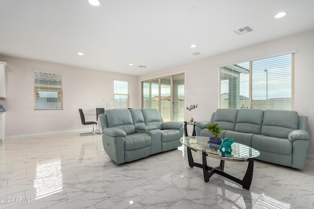 living area with marble finish floor, baseboards, visible vents, and recessed lighting