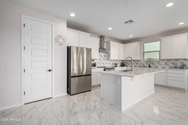 kitchen with marble finish floor, visible vents, appliances with stainless steel finishes, a sink, and wall chimney exhaust hood