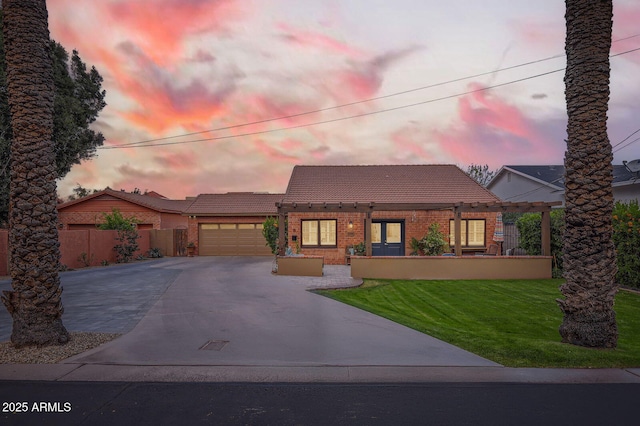 view of front of property featuring a tile roof, brick siding, concrete driveway, an attached garage, and fence