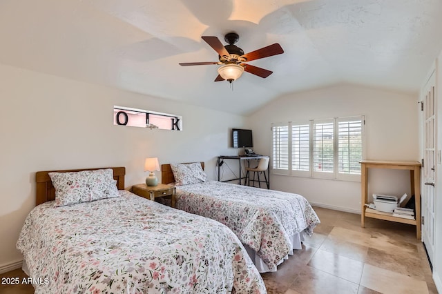 tiled bedroom featuring vaulted ceiling, ceiling fan, and baseboards