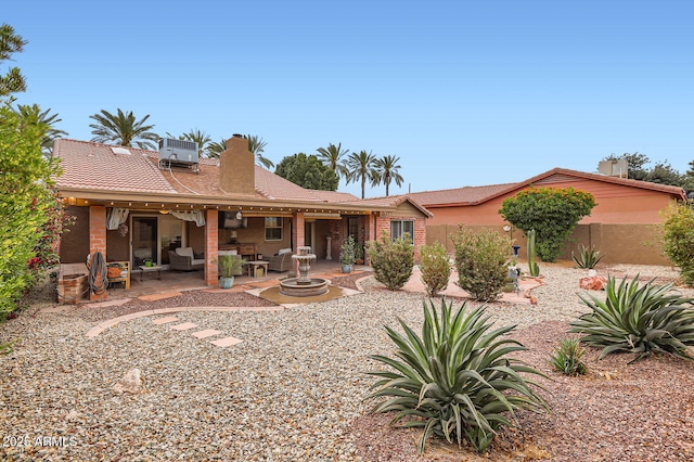 back of property with a patio area, fence, a chimney, and central air condition unit