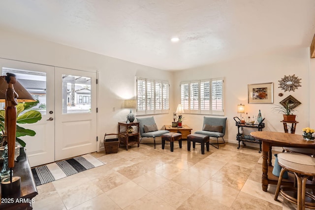 entryway with baseboards and french doors