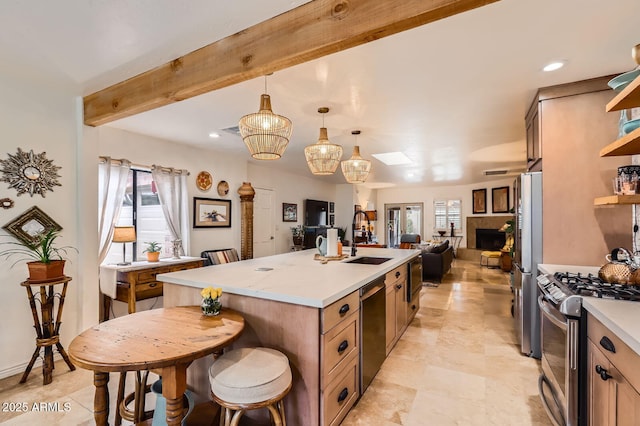 kitchen featuring appliances with stainless steel finishes, open floor plan, a sink, open shelves, and beam ceiling