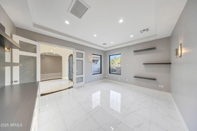 26204 S Washington St, Chandler, AZ 85249 - unfurnished living room with a raised ceiling, arched walkways, marble finish floors, and recessed lighting