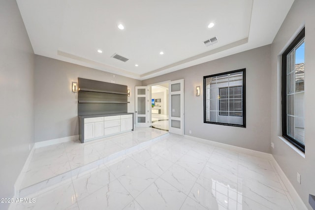 26204 S Washington St, Chandler, AZ 85249 - unfurnished living room with a tray ceiling, recessed lighting, and light marble finish floors