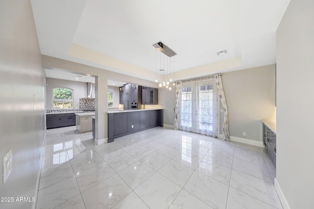 26204 S Washington St, Chandler, AZ 85249 - kitchen with french doors, a raised ceiling, light countertops, light marble finish floors, and modern cabinets
