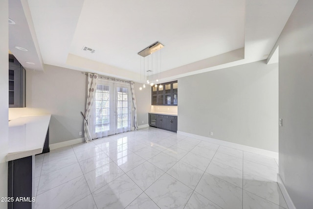26204 S Washington St, Chandler, AZ 85249 - unfurnished dining area with a raised ceiling, french doors, and light marble finish flooring
