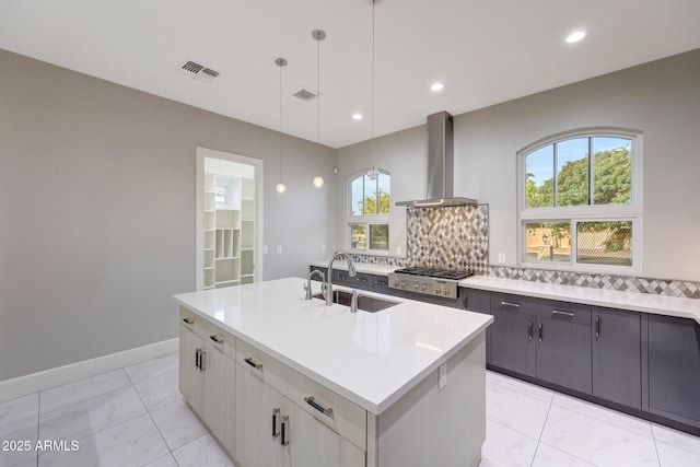 26204 S Washington St, Chandler, AZ 85249 - kitchen featuring island range hood, stainless steel gas cooktop, light marble finish floors, tasteful backsplash, and light countertops