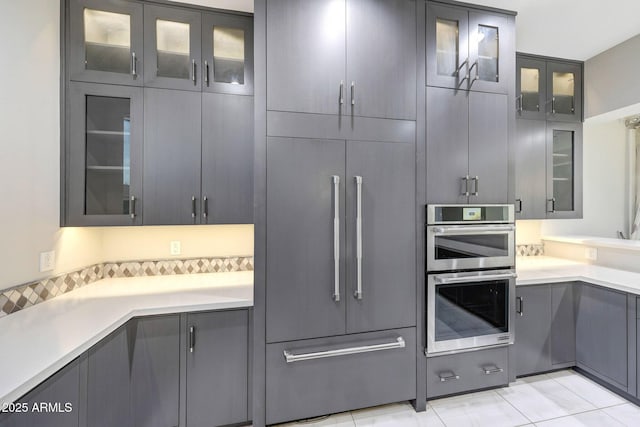 26204 S Washington St, Chandler, AZ 85249 - kitchen featuring gray cabinetry, stainless steel double oven, paneled built in fridge, and glass insert cabinets