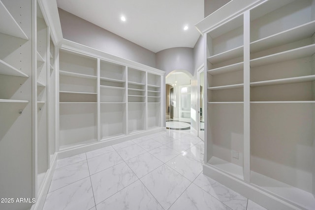 26204 S Washington St, Chandler, AZ 85249 - hallway featuring arched walkways, marble look tile flooring, and recessed lighting