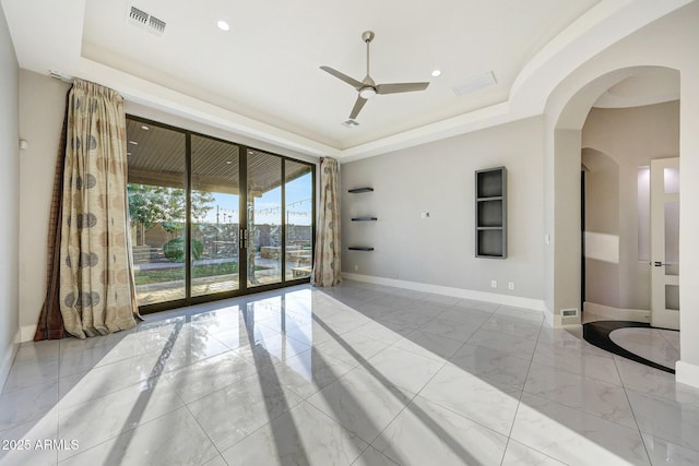 26204 S Washington St, Chandler, AZ 85249 - unfurnished room featuring a raised ceiling, marble finish floors, a ceiling fan, arched walkways, and recessed lighting