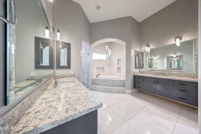 26204 S Washington St, Chandler, AZ 85249 - full bathroom featuring a bath, two vanities, a stall shower, and marble finish floors