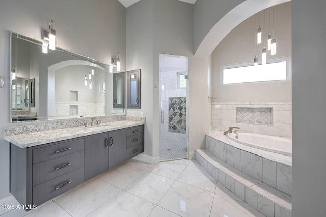 26204 S Washington St, Chandler, AZ 85249 - full bathroom featuring a bath, a shower stall, vanity, marble finish floors, and a towering ceiling